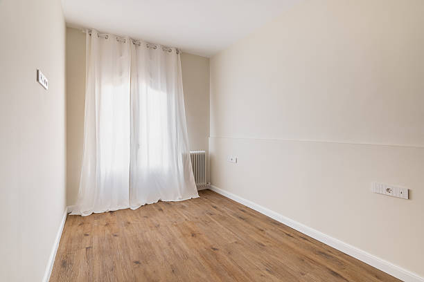 istock Cozy neutral-toned empty room with sheer curtains and wooden floor 2207361485