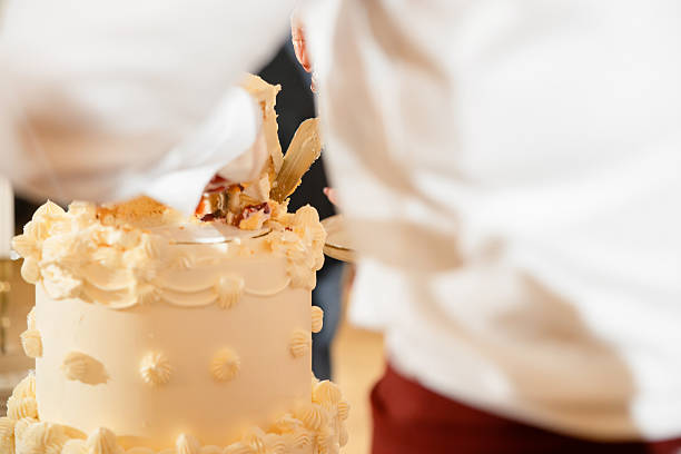 istock Bride and Groom Cutting a Luxurious Wedding Cake – Sweet Tradition and Celebration 2207361577