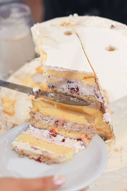 The bride and groom cut into an elegant, luxurious wedding cake, a timeless tradition symbolizing their union. This beautifully decorated dessert is the highlight of the wedding reception, adding sweetness to the celebration.