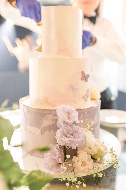 istock Bride and Groom Cutting a Luxurious Wedding Cake – Sweet Tradition and Celebration 2207362039