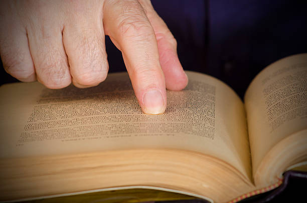 Reading old book on table