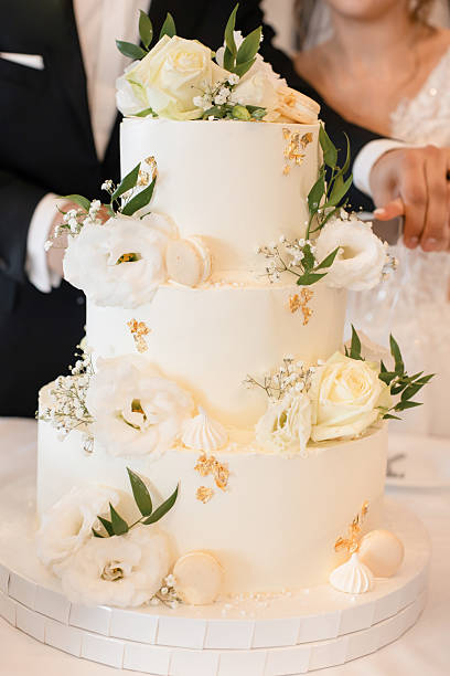 istock Bride and Groom Cutting a Luxurious Wedding Cake – Sweet Tradition and Celebration 2207362128