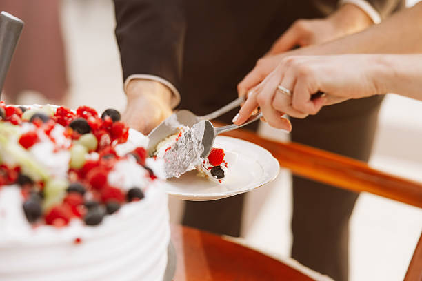 istock Bride and Groom Cutting a Luxurious Wedding Cake – Sweet Tradition and Celebration 2207362452