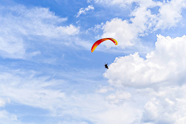 Paragliding adventure with a red and blue parachute