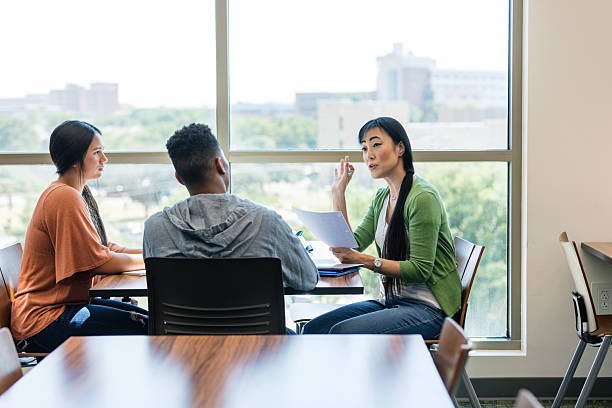 istock Professor Giving Feedback to Students During a Meeting 2207367599