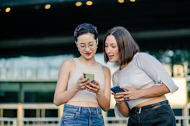 istock Generation Z and millennial girls using a smartphone 2207369989