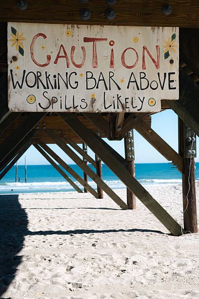 istock funny bar sign under the pier at the beach 2207371502