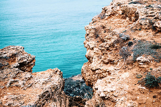 High angle view of sea bay surrounded by sandstone rocks