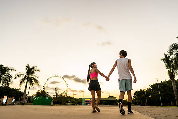 istock Young couple walking with holding hands outdoors 2207374009