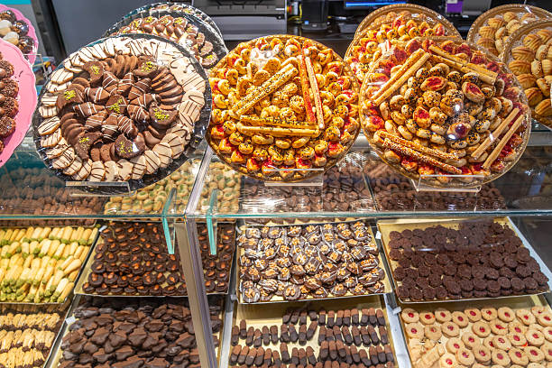 istock A display case with pastries, sweets and cookies, chocolate coated treats, candies, assorted cookies, and baked goods in Saudi Arabia 2207374163