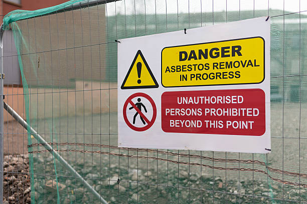 istock Building Site Attention Danger Asbestos Removal and Demolition in Progress Sign on Temporary Heras Fence Panel with Blurred Background Buildings 2207374218