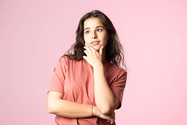 istock Pensive woman hand on chin looking up 2207377713