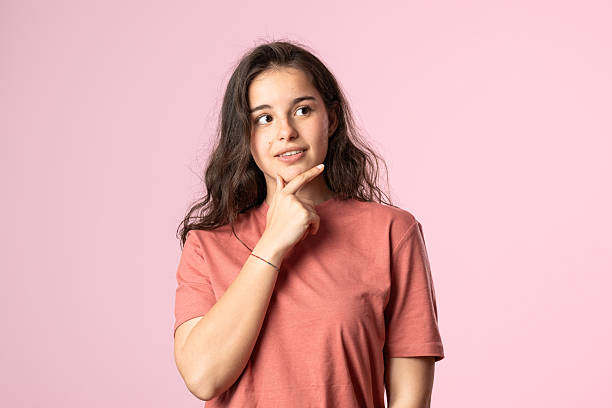 istock Woman thinking on pink background 2207379191