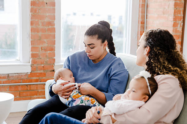 istock Two Mothers Bonding with Their Infants, Sharing Support and Love 2207379374