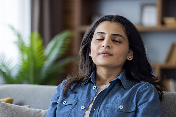 istock A serene woman finds peace and calm while practicing mindfulness meditation in her living room at home. 2207380033