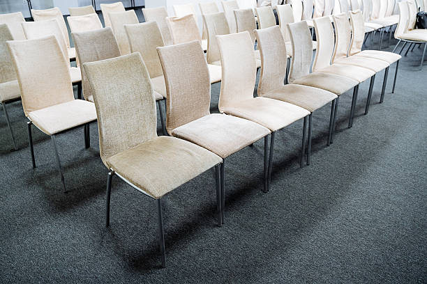 istock In a wellorganized room, a neatly aligned row of chairs is present, ready for use. This setup creates an inviting atmosphere for gatherings or events that may take place here 2207382659