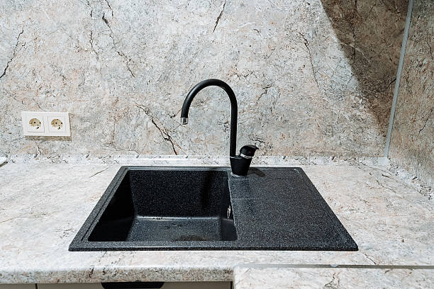 istock In a beautifully designed kitchen, there is a sleek, black sink accompanied by a stylish black faucet, both elegantly set on a counter that enhances the overall aesthetic of the space 2207382696