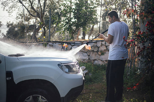 istock Man washing car in garden 2207389589