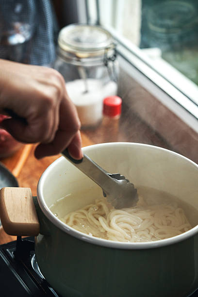 istock Cooking Udon Noodles in a Cooking Pot 2207389993