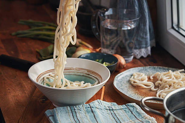 Preparing Kake Udon - Udon Noodle Soup Garnished with Sliced Green Onions