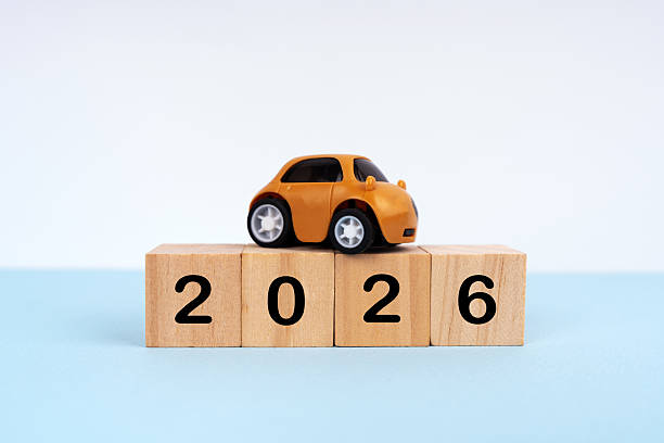istock 2026 written on wood blocks with mini car model on top.  New Year plan concept 2207390795