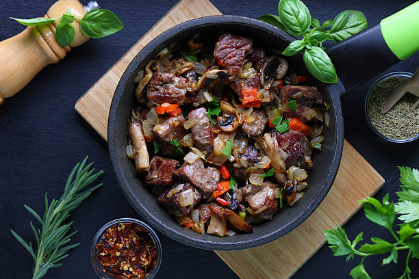 Beef onions peppers simmering in frying pan