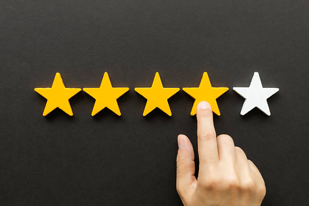 istock Hand Giving Four-Star Rating on Black Background 2207392747
