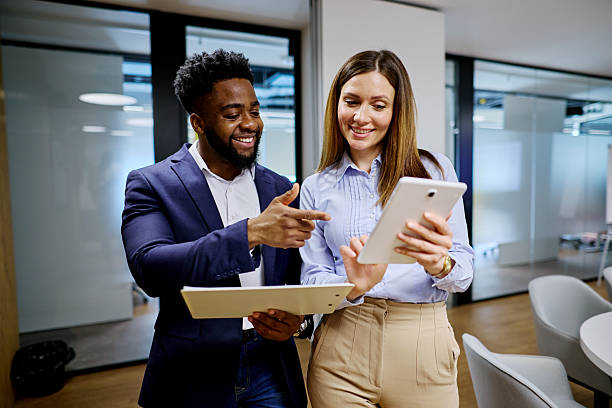 istock Business partners discussing using digital tablet and clipboard in modern office 2207394288