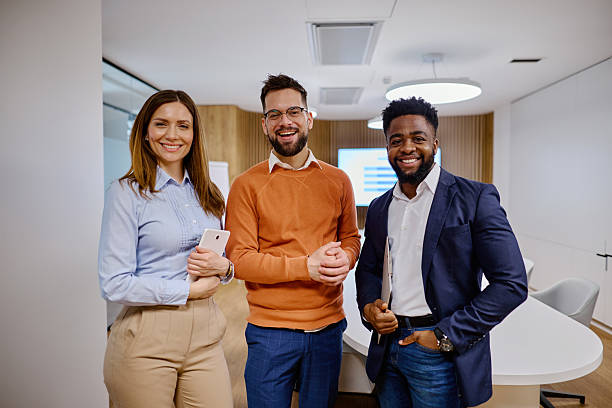 istock Smiling business team posing in modern office 2207394300