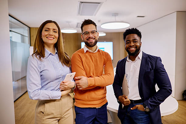 istock Smiling business team posing in modern office 2207394306