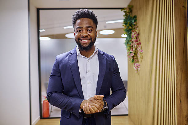 istock Confident young businessman smiling in modern office 2207394512