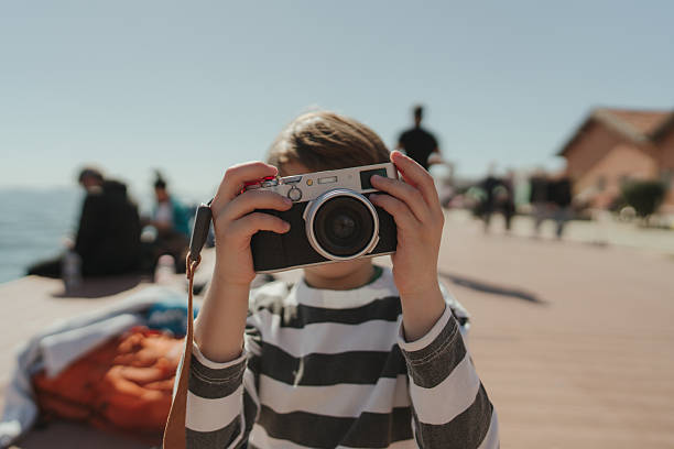 istock Little photographer on the pier 2207396286