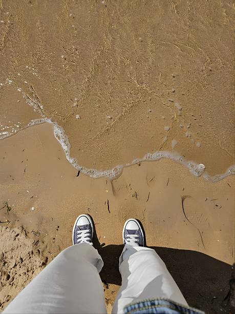 Stepping on the shore of the beach