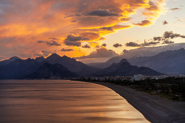 Sunset with dramatic sky over Konyaalti Beach, Antalya, Turkiye