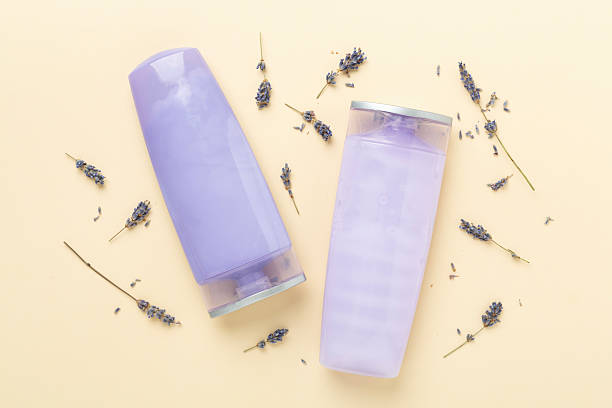 istock Cosmetic bottles with lavender on color background, top view 2207405958