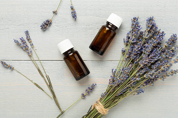 istock Bottles with lavender extract on wooden background,, top view 2207405968
