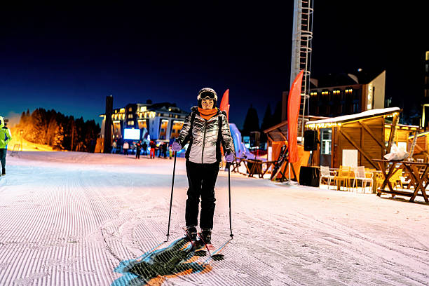 istock Night skiing scene featuring a bundled individual with dimly lit background 2207409555