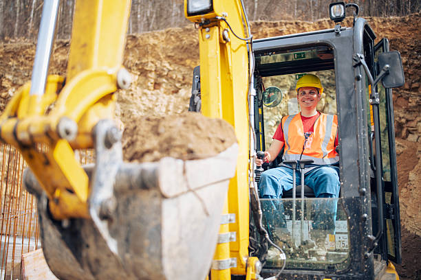 istock Cheerful excavator driver digging trench at construction site. 2207412076