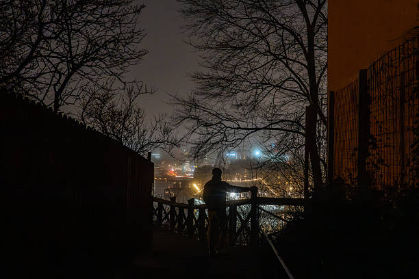 Stockholm, Sweden A man stands on the  landmark Monteliusvagen outlook point on the Sodermalm island at night.