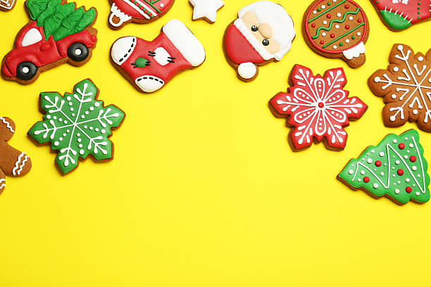 Different tasty Christmas cookies on yellow background, flat lay. Space for text