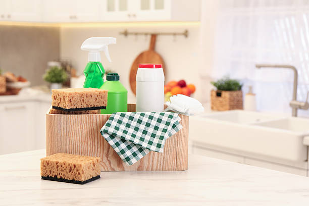 istock Different cleaning supplies on table in kitchen. Space for text 2207415443