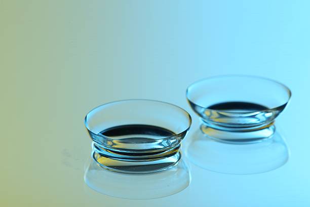 Pair of contact lenses on mirror surface, closeup