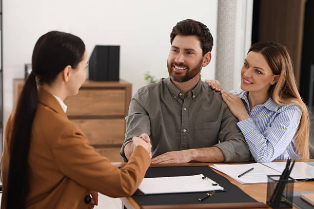 istock Lawyer shaking hands with clients in office 2207415806