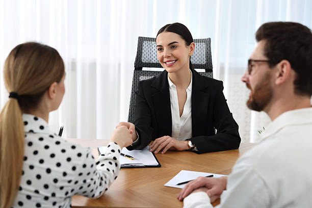 istock Lawyer shaking hands with clients in office 2207415874
