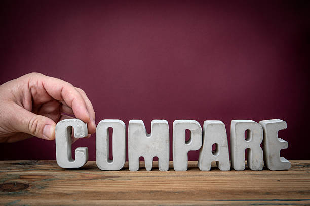 COMPARE Word Created from Concrete Alphabet Letters on Wooden Desk