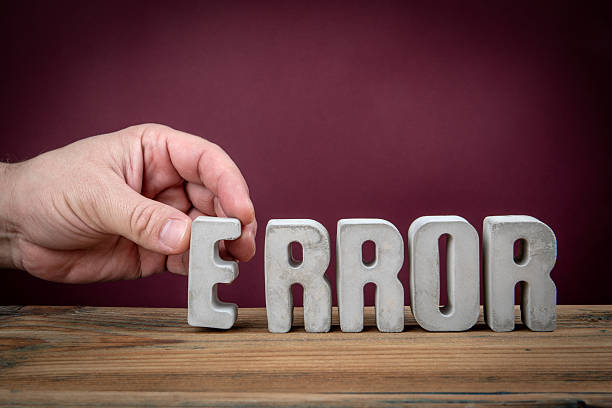istock Error Word Created from Concrete Alphabet Letters on Wooden Desk 2207416483