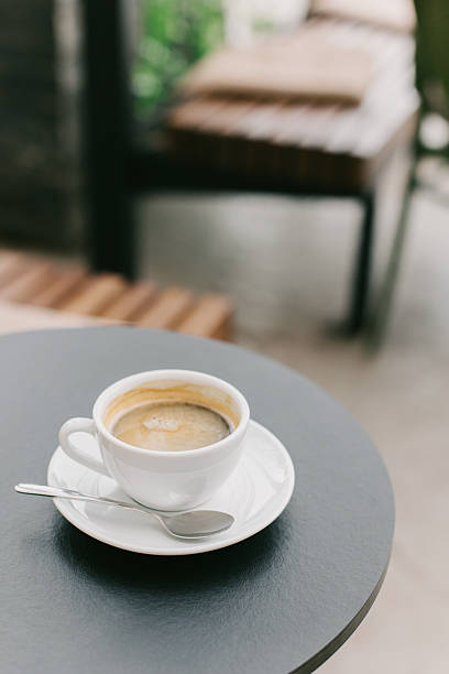 istock White ceramic cup of black coffee on a table in a street cafe. 2207418365