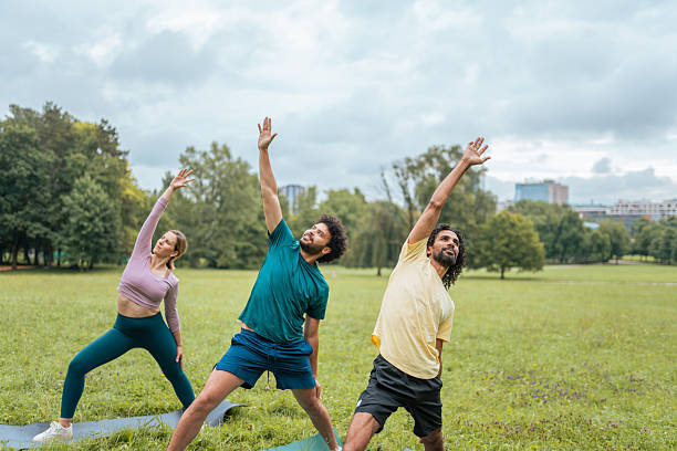 istock Diverse Group Engages in Outdoor Yoga Session 2207421149