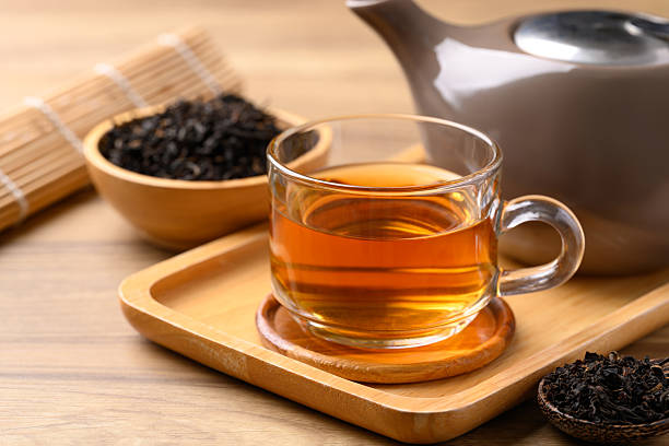 istock Black tea in cup glass with dried tea leaves, Healthy herbal drink 2207428607
