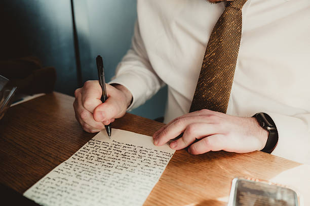 istock Groom writing wedding vows on paper before ceremony 2207430287